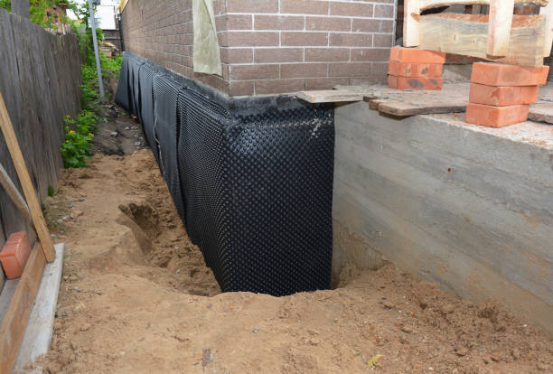 Happy homeowners after waterproofing job in Alton